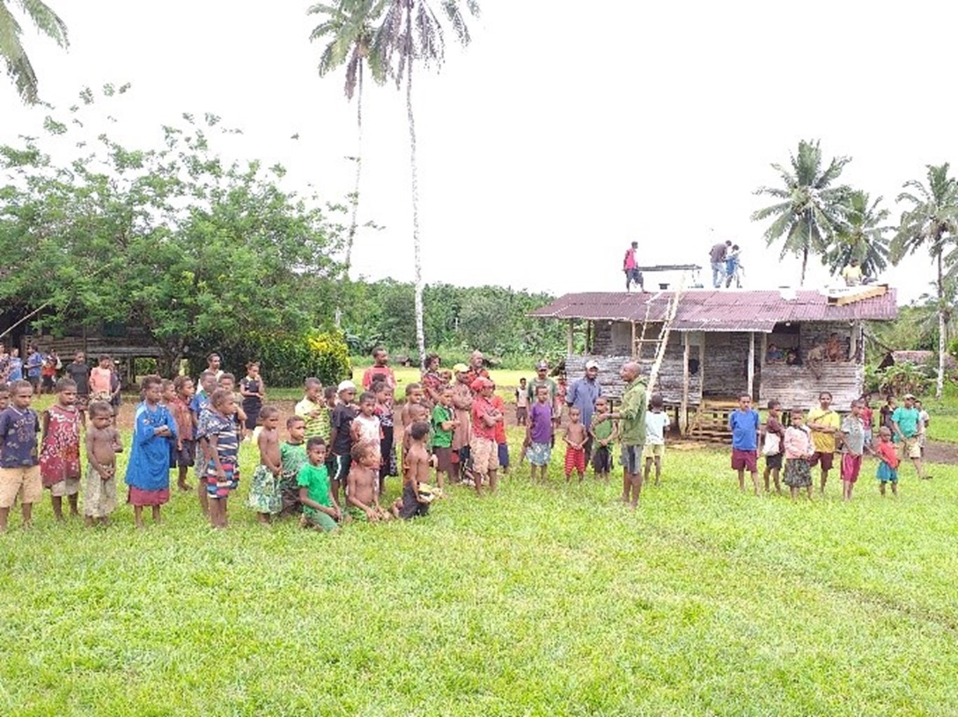 Grateful villagers in front of the Honinabi Aid Post when the satellite and solar equipment was installed. SDP. Kacific satellite internet. Papua New Guinea. PNG. Sustainable development programme